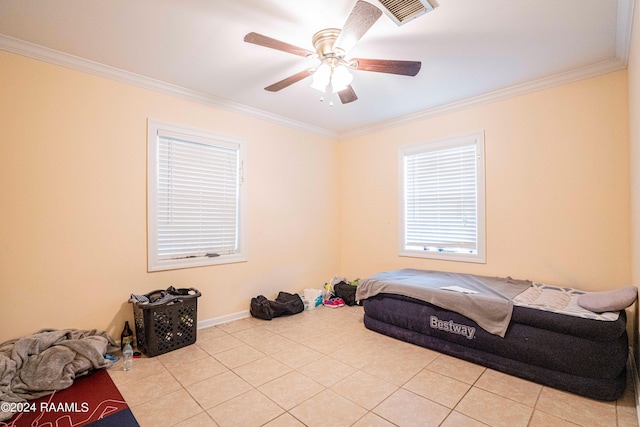 tiled bedroom with ornamental molding and ceiling fan