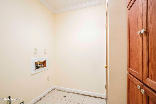 clothes washing area with light tile patterned floors, hookup for a washing machine, and crown molding