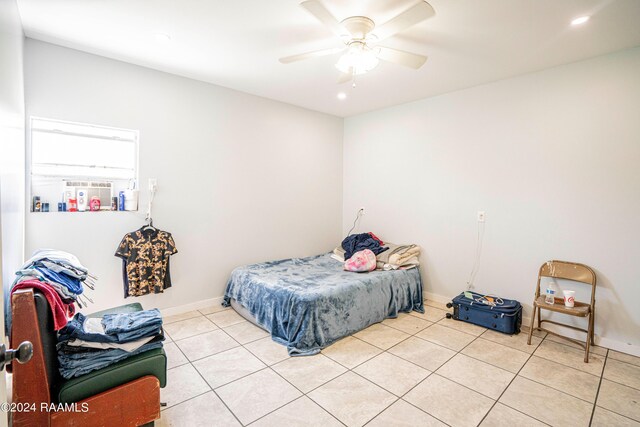 bedroom with ceiling fan and light tile patterned floors