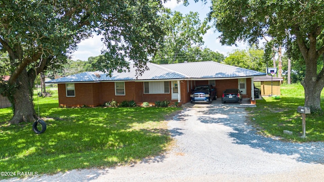 single story home featuring a carport and a front yard