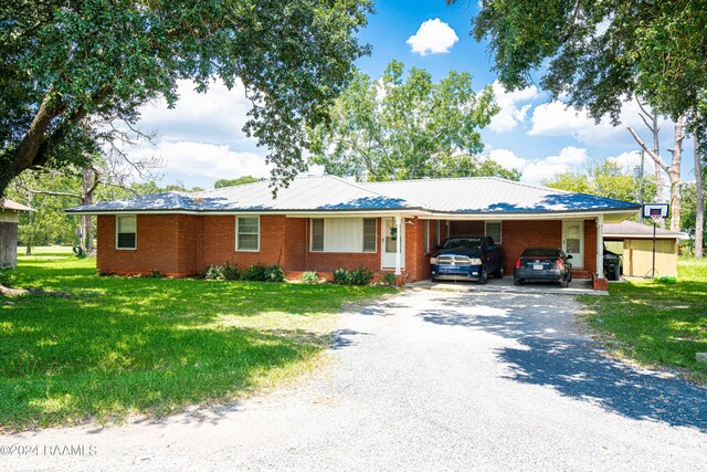 single story home with a front yard and a carport