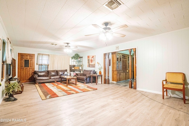 living room featuring crown molding, ceiling fan, and light wood-type flooring