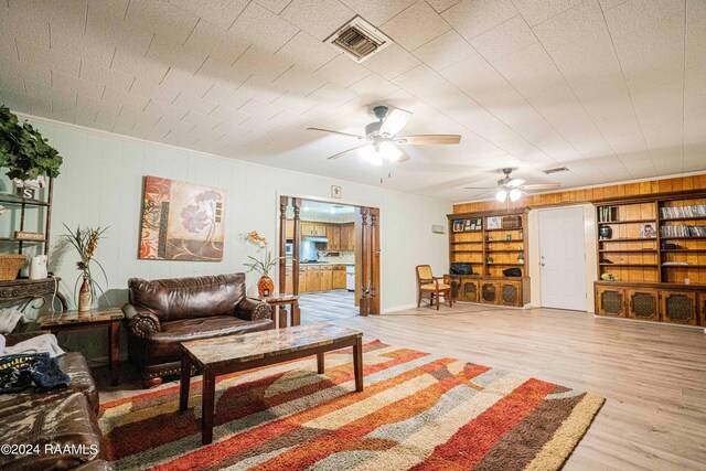 living room featuring ceiling fan and light wood-type flooring