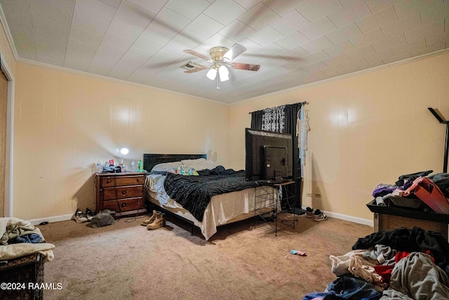 carpeted bedroom featuring crown molding and ceiling fan