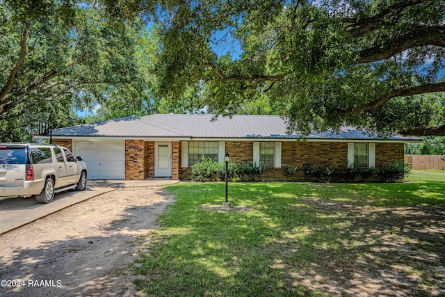 single story home with a garage and a front yard