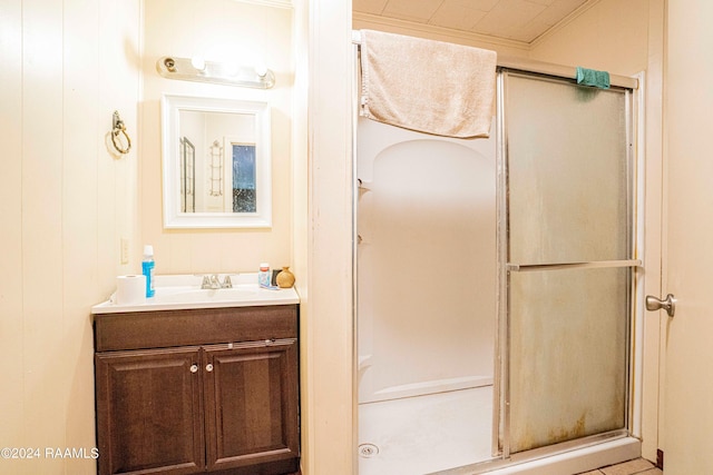 bathroom with vanity and a shower with door