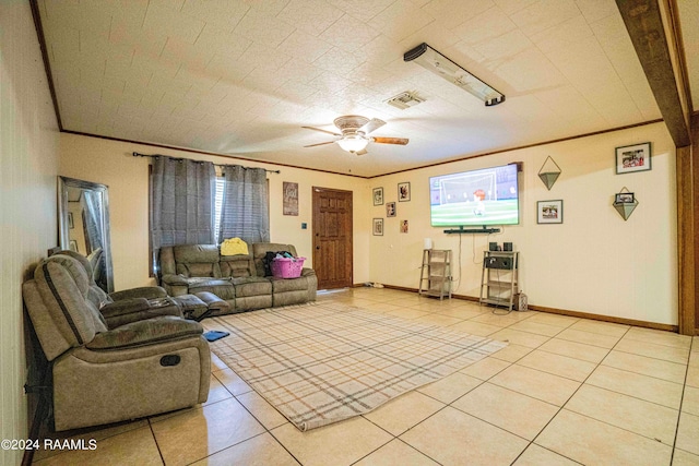 living room with crown molding, ceiling fan, and light tile patterned flooring