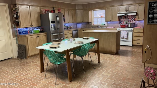 kitchen with brick floor, stainless steel appliances, light countertops, decorative backsplash, and under cabinet range hood