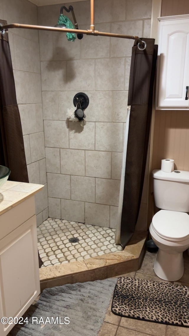 full bath featuring toilet, a stall shower, and vanity