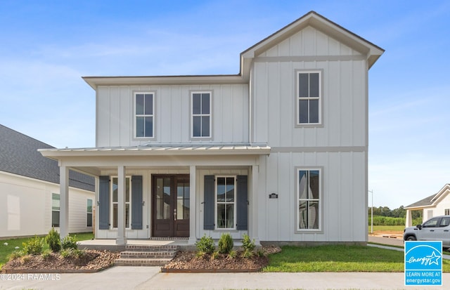 modern farmhouse featuring a standing seam roof, metal roof, a porch, and board and batten siding