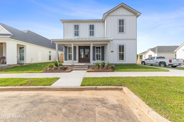 modern inspired farmhouse featuring board and batten siding, a front yard, french doors, and a porch