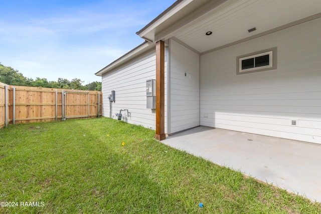 exterior space featuring a patio area, fence, and a lawn