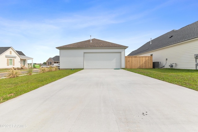 exterior space with a garage, central AC, and a lawn