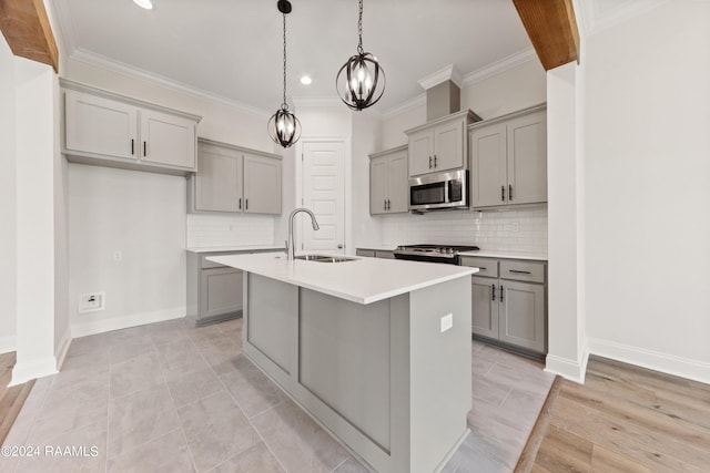 kitchen with a sink, appliances with stainless steel finishes, and gray cabinets