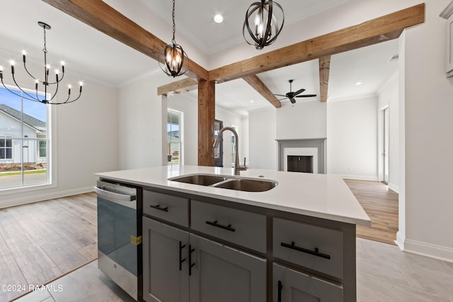 kitchen with dishwasher, ornamental molding, beamed ceiling, gray cabinets, and a sink