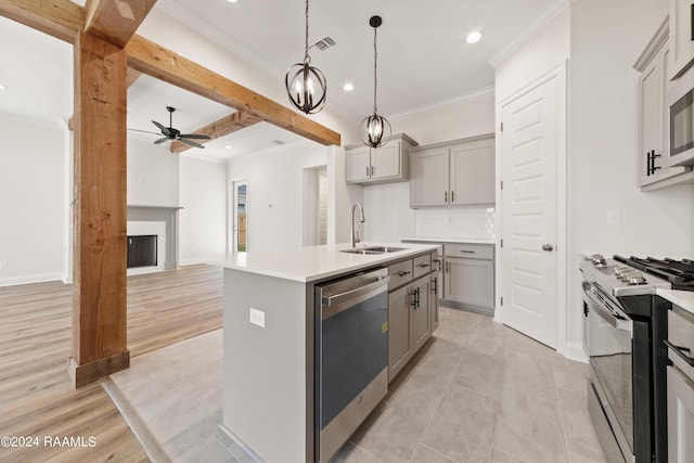 kitchen featuring visible vents, dishwasher, gas range oven, gray cabinetry, and a sink