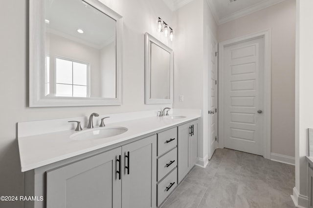 bathroom featuring double vanity, ornamental molding, and a sink