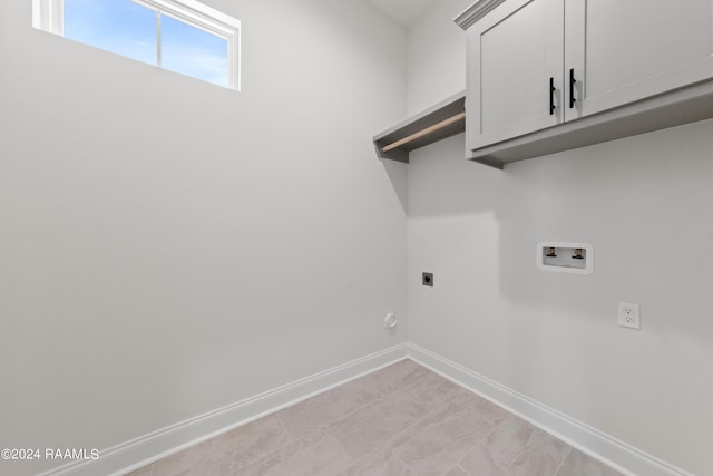 laundry room featuring hookup for a washing machine, cabinet space, baseboards, and electric dryer hookup