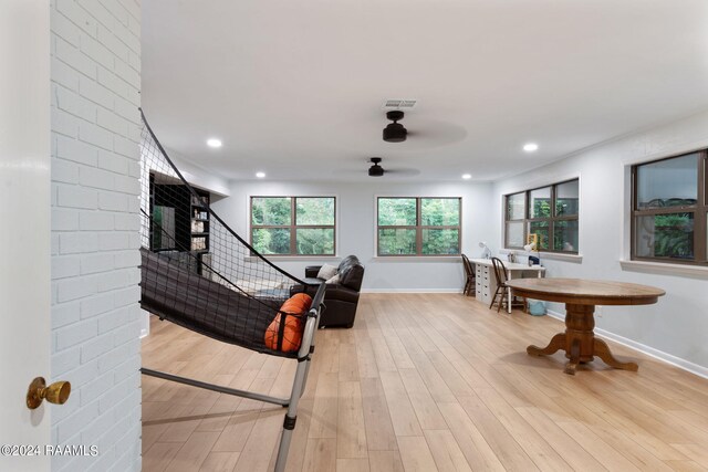 living room featuring ceiling fan and light hardwood / wood-style floors