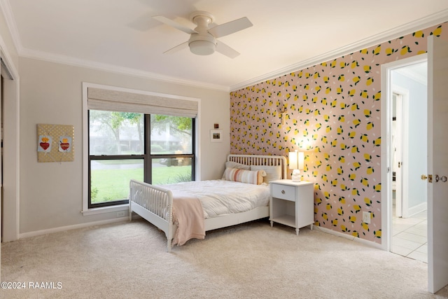 carpeted bedroom featuring ornamental molding and ceiling fan