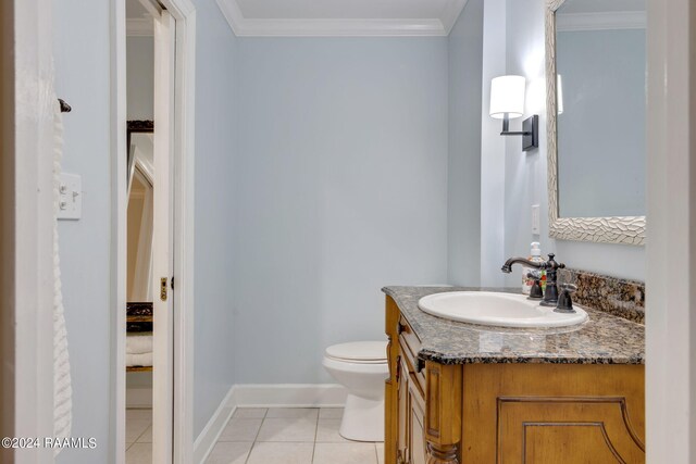 bathroom with crown molding, vanity, toilet, and tile patterned floors