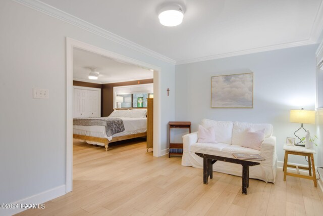 bedroom featuring crown molding and light hardwood / wood-style flooring