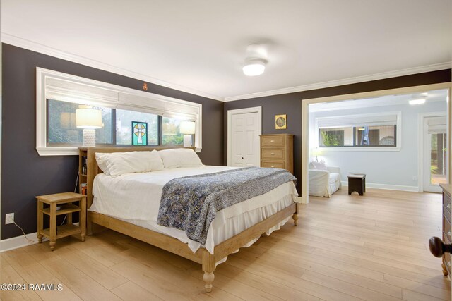 bedroom featuring light wood-type flooring and multiple windows