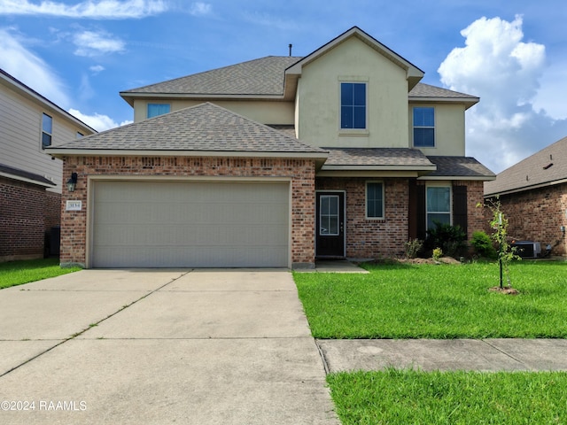 view of front property featuring a front lawn, central AC, and a garage