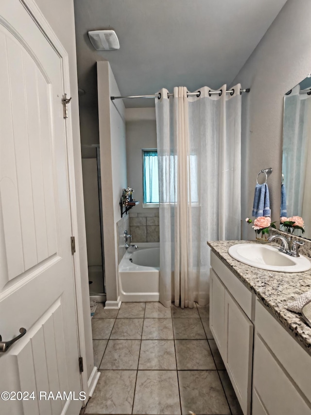 bathroom featuring vanity, shower with separate bathtub, and tile patterned floors