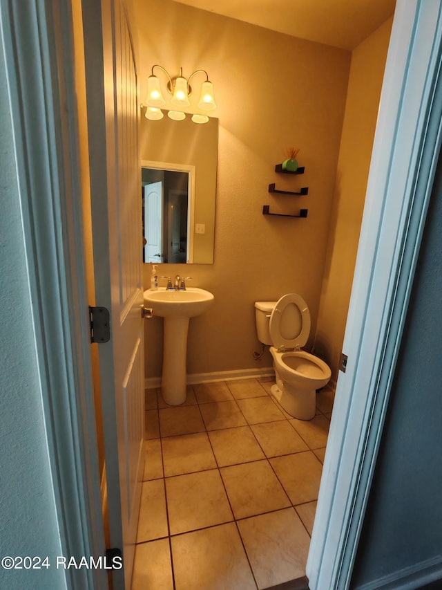 bathroom with toilet and tile patterned floors