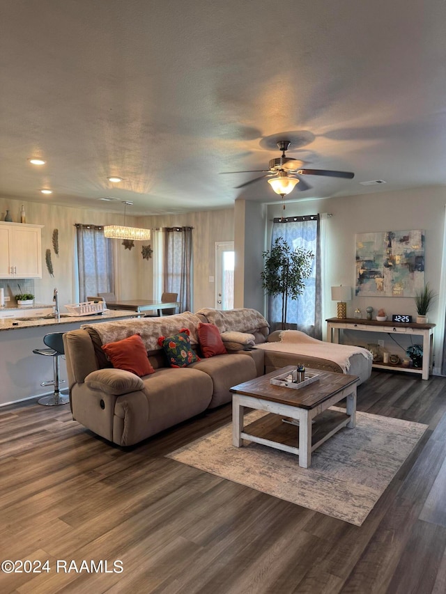 living room with ceiling fan, sink, and dark hardwood / wood-style flooring