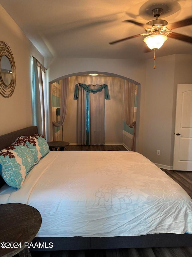 bedroom with ceiling fan and hardwood / wood-style flooring