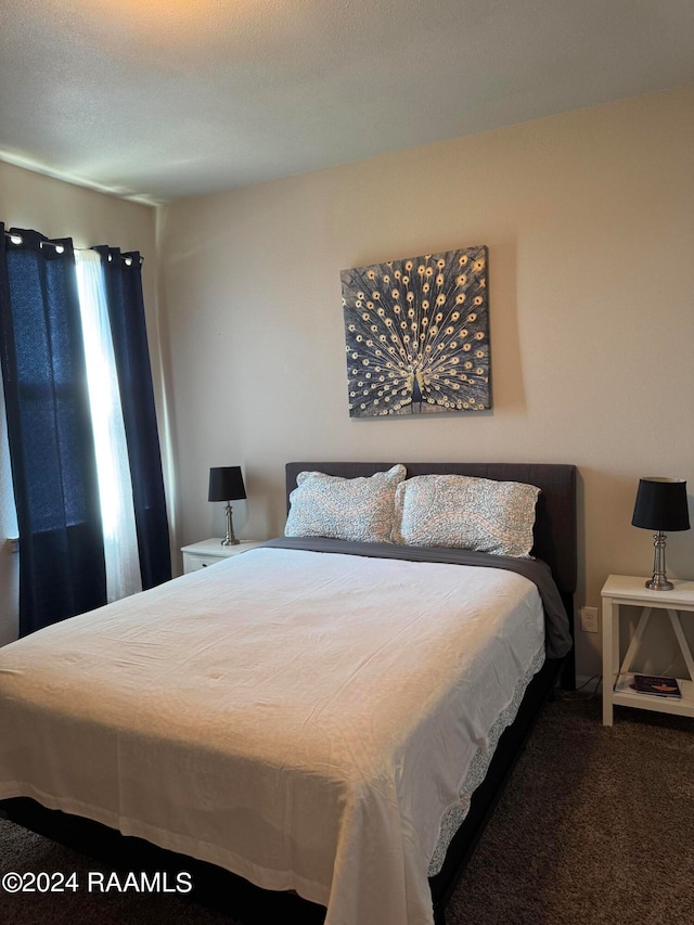 bedroom featuring carpet floors and a textured ceiling