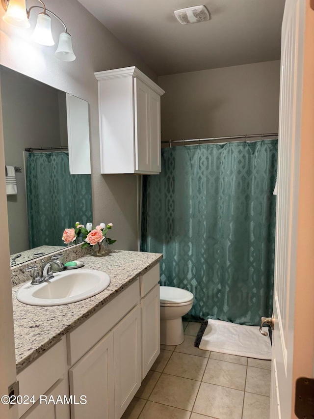 bathroom with tile patterned floors, toilet, vanity, and a shower with curtain