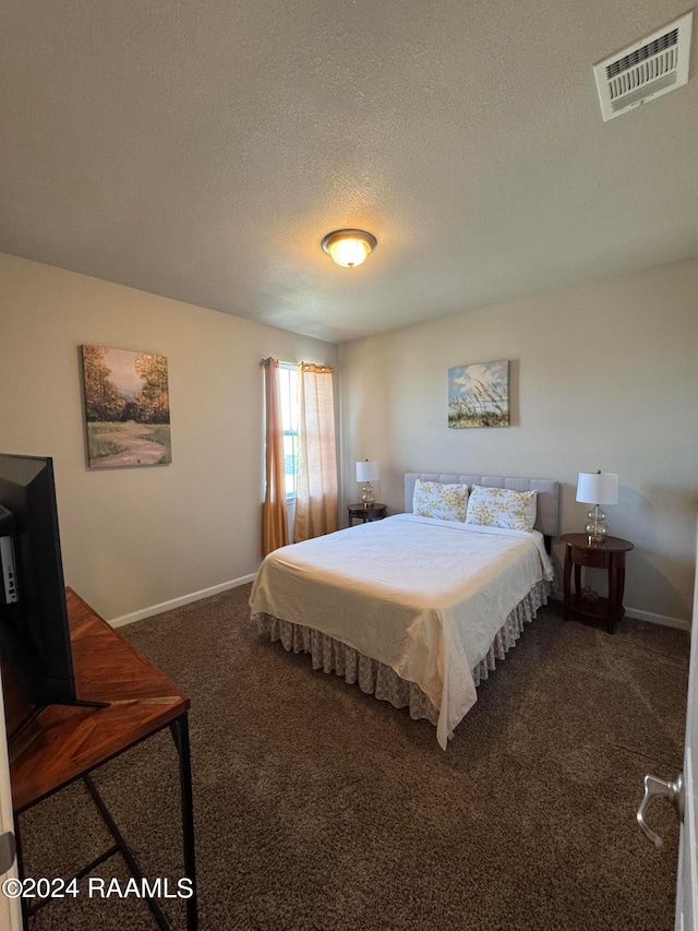 carpeted bedroom with a textured ceiling