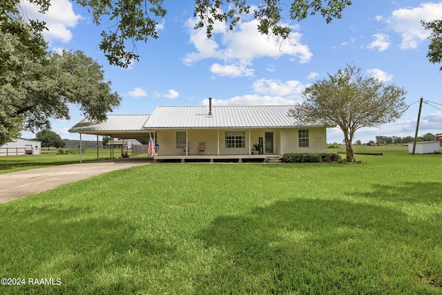 7224 Plum Rd, Erath, LA 70533 - country-style home featuring metal roof, a porch, driveway, a carport, and a front lawn