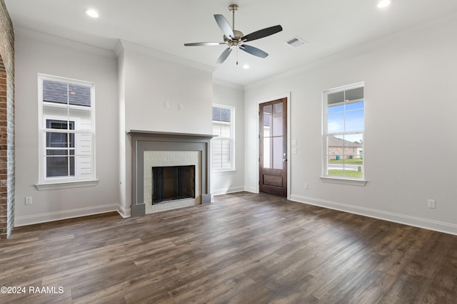 unfurnished living room with dark hardwood / wood-style flooring, ceiling fan, and crown molding