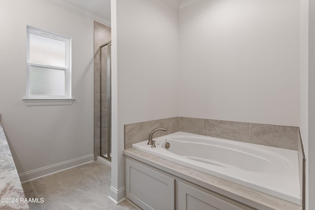 bathroom featuring ornamental molding and independent shower and bath