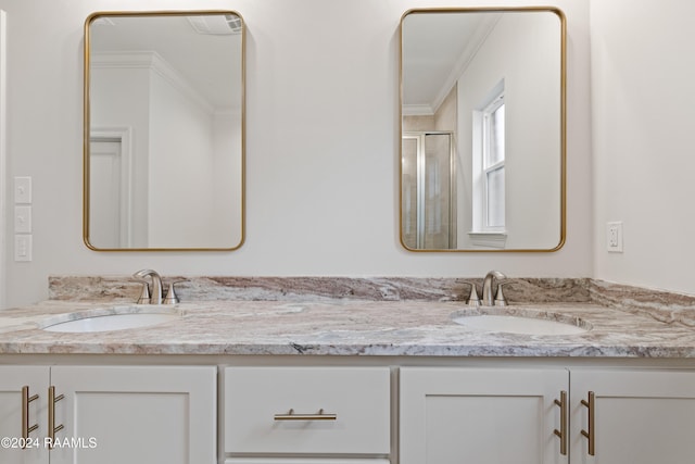 bathroom with an enclosed shower, vanity, and crown molding