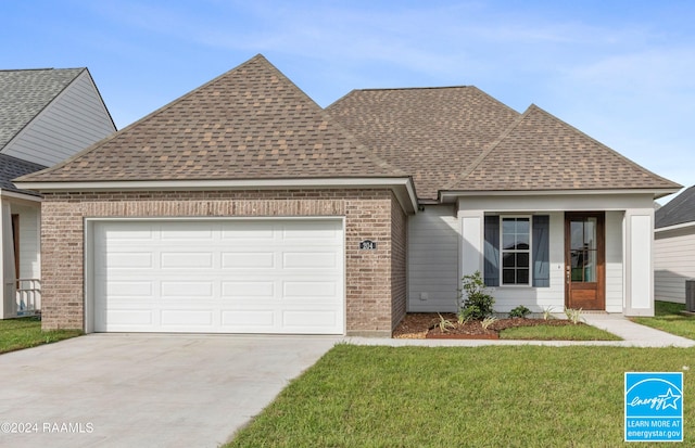 view of front of property with a garage and a front lawn