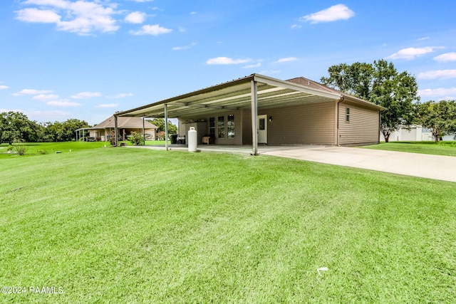 rear view of house with a yard and a carport