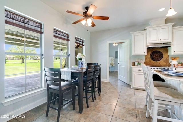 dining room featuring light tile patterned flooring and ceiling fan