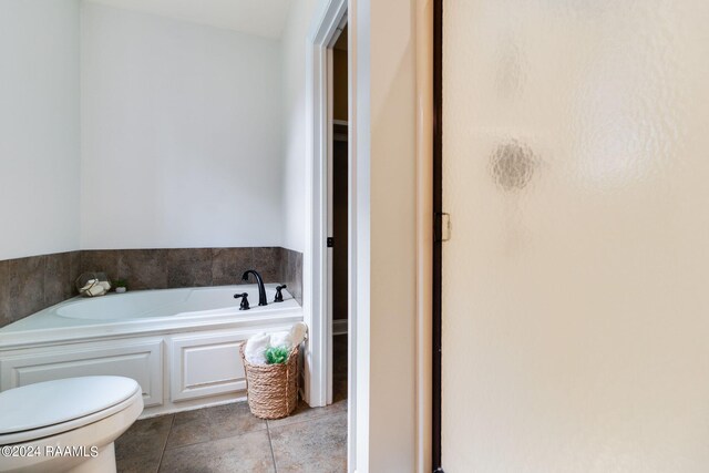 bathroom featuring tile patterned floors, toilet, and separate shower and tub