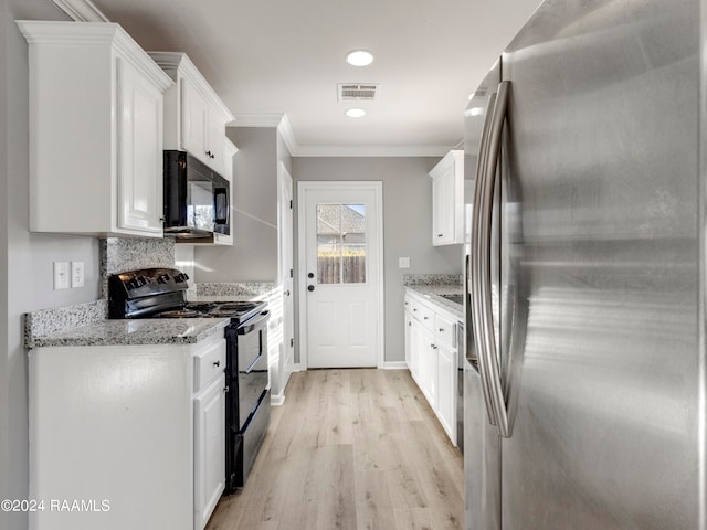 kitchen featuring light wood-type flooring, light stone countertops, white cabinetry, black appliances, and ornamental molding