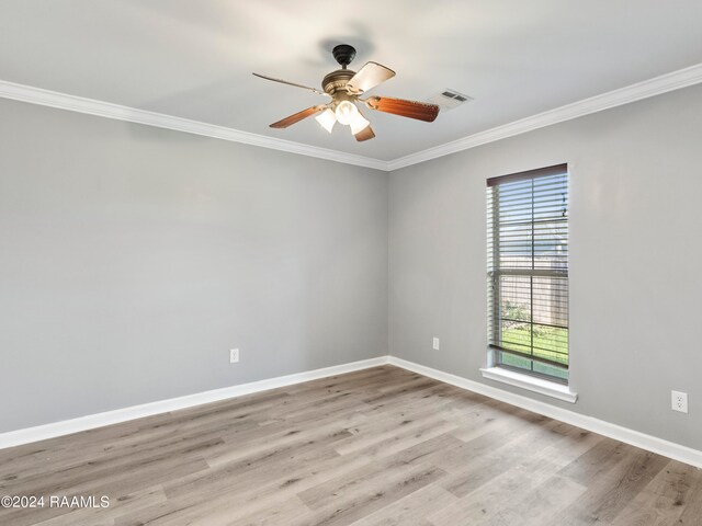 spare room featuring light wood-type flooring, ceiling fan, and crown molding