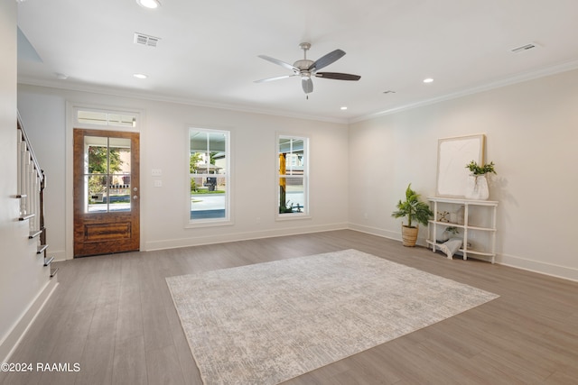 interior space featuring ceiling fan, ornamental molding, and light hardwood / wood-style floors