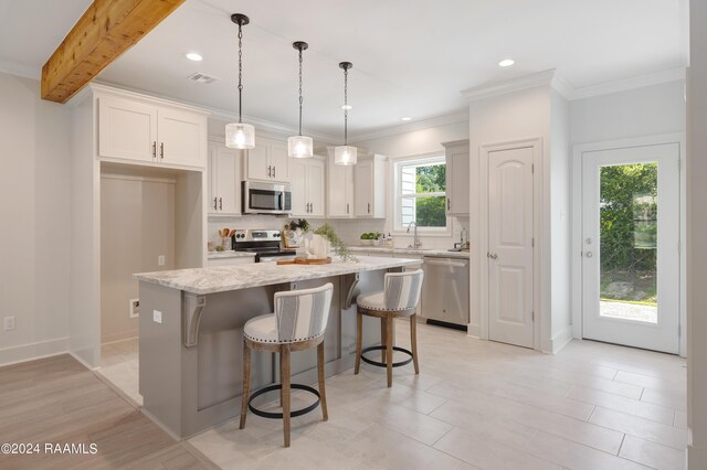 kitchen featuring stainless steel appliances, pendant lighting, a kitchen breakfast bar, tasteful backsplash, and a kitchen island