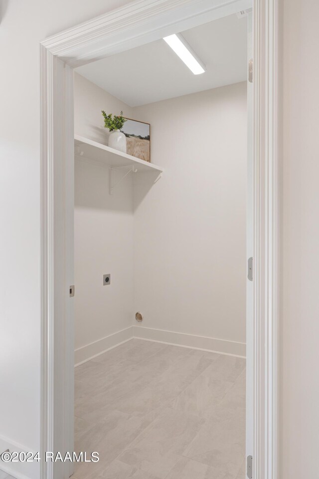 washroom with light tile patterned floors and hookup for an electric dryer