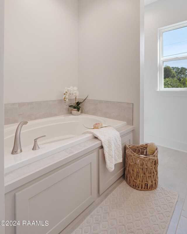 bathroom featuring tile patterned floors and a washtub