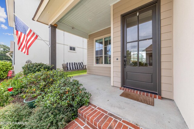 property entrance featuring covered porch